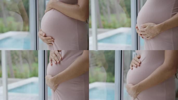 孕妇抱着她的肚子孕期温馨肚中生命期待新生