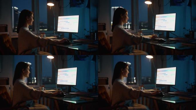 女经理晚上在Dark Loft办公室的Creative Agency的台式计算机上工作。翻新的时尚设