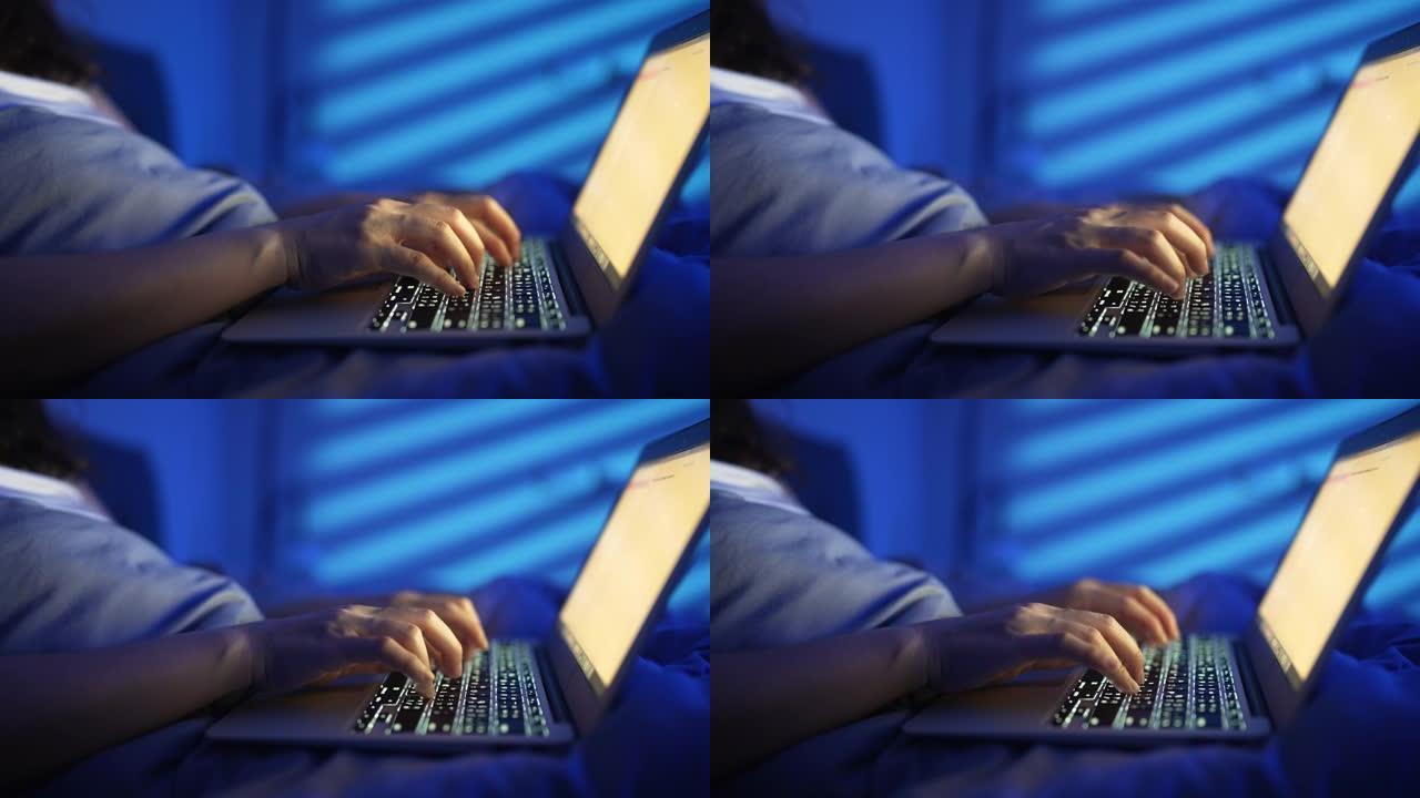 夜间使用笔记本电脑的特写手女人