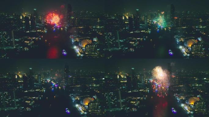 空中无人机视角多颜色的烟花表演在天空之城。新年前夜。摩天大楼和城市景观庆祝夜晚的灯光