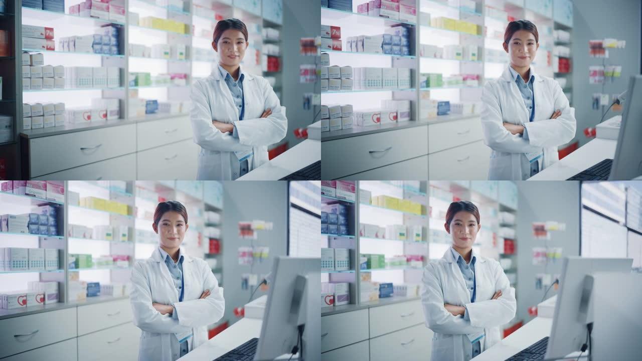 药房药店: 美丽的亚洲女药剂师穿着白色实验室外套的肖像，看着相机，微笑着，在她的收银台后面，货架上放