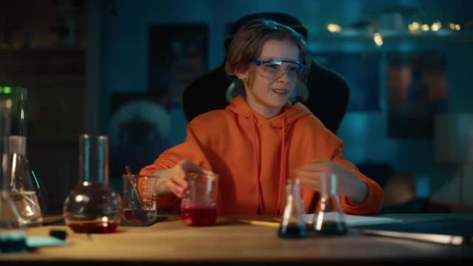 戴安全护目镜的聪明小男孩在烧杯中混合化学物质，并在笔记本电脑上写下结果。青少年进行教育科学爱好实验，