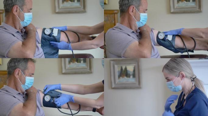 高级男性患者使用血压计的女护士