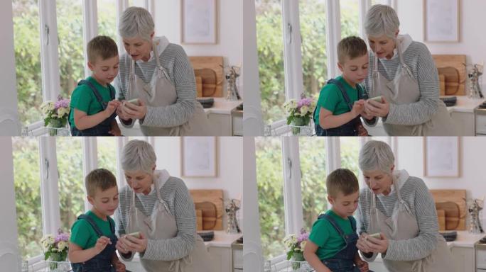 快乐的小男孩向奶奶展示如何使用智能手机教学奶奶现代技术智能孩子在家帮助奶奶用手机