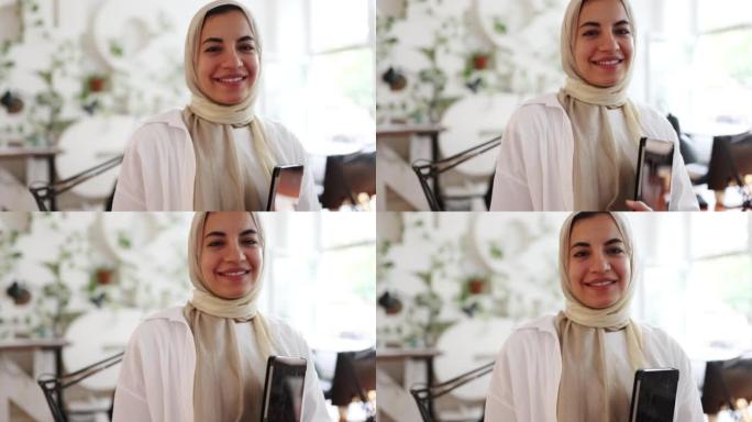一位自信的年轻中东妇女在办公室戴着头巾的特写肖像