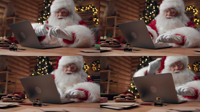 圣诞老人正在视频聊天，使用笔记本电脑并打手势