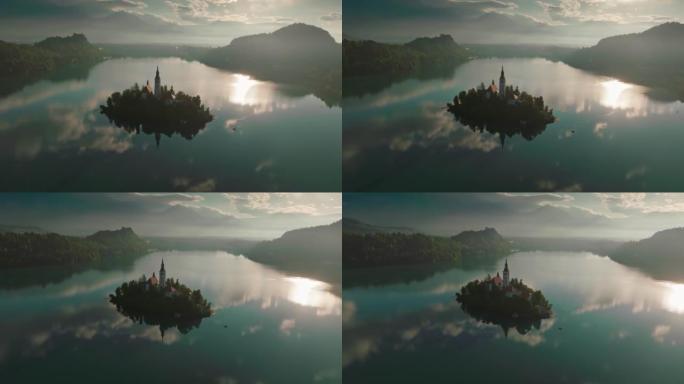 斯洛文尼亚布莱德湖日出的鸟瞰图。在布莱德湖 (Bled lake) 的玛丽圣母升天教堂 (Churc