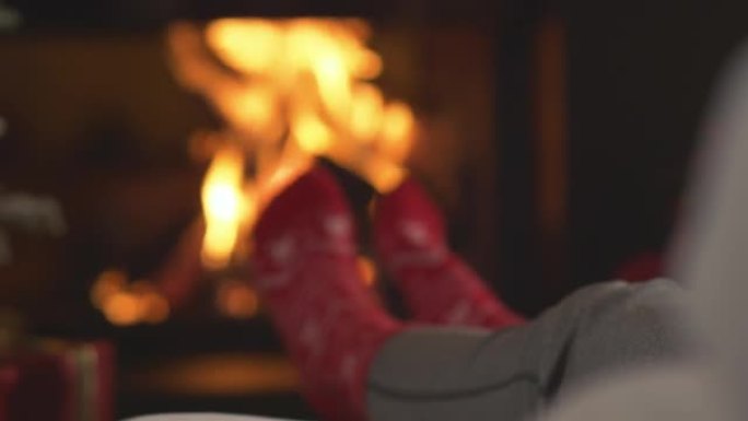 特写: 女士在壁炉和圣诞树旁放松时喝热茶