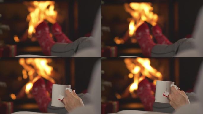 特写: 女士在壁炉和圣诞树旁放松时喝热茶