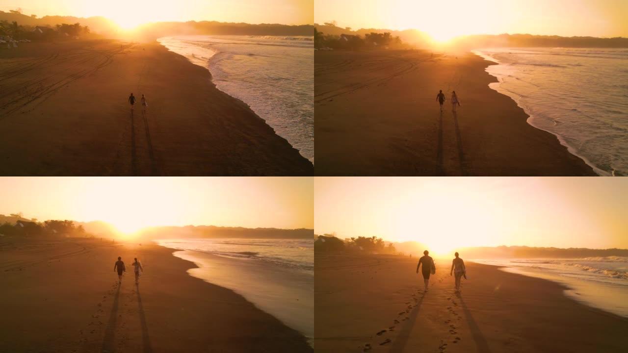 空中轮廓: 几个冲浪者在冲浪后在海滩上走向太阳