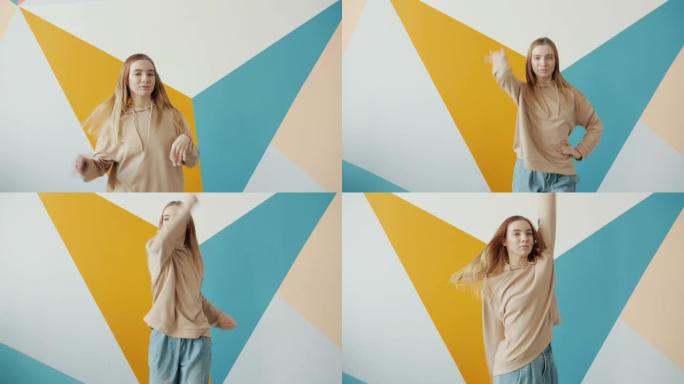 可爱的少女在舞蹈学校舞厅跳舞，微笑着看着相机