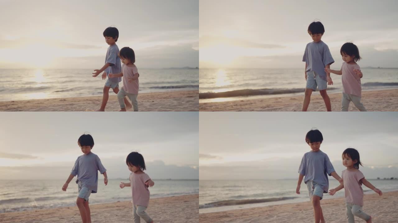 亚洲男孩和小女孩在海滩上散步。
