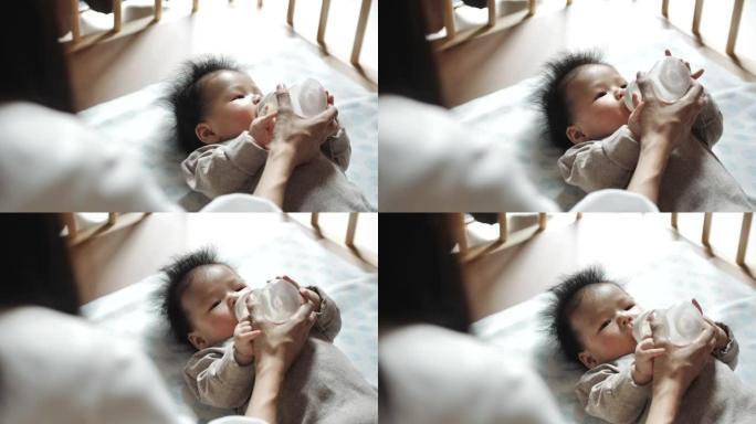 亚洲母亲正在用奶瓶母乳喂养