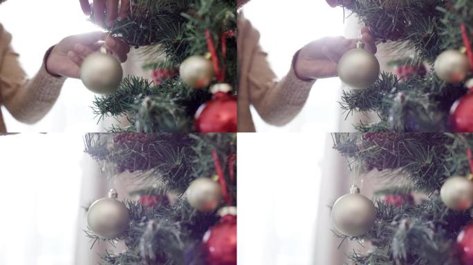 4k特写镜头，一个无法辨认的女人在家里装饰圣诞树