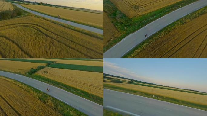 空中休闲骑自行车的人在日落时分在乡村锻炼