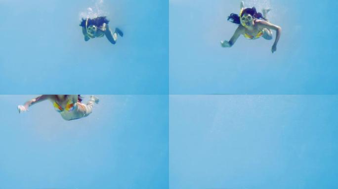 黑发女人穿着浮潜跳进游泳池