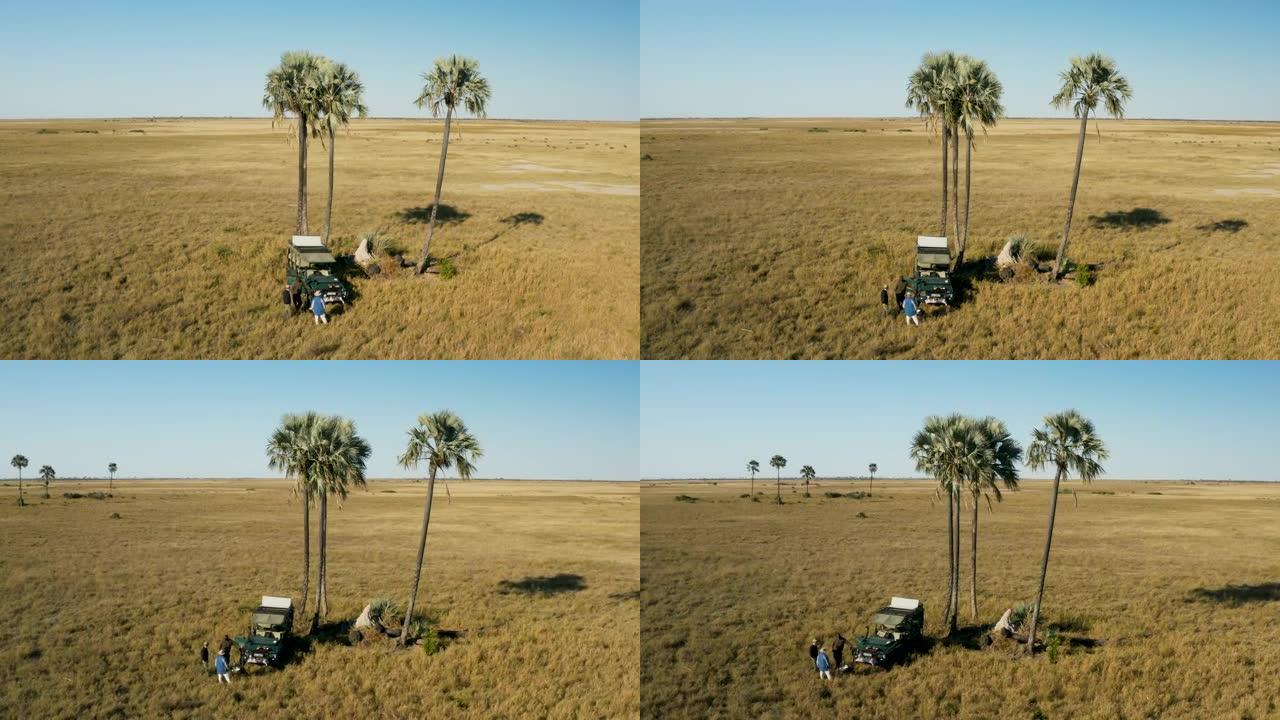 在博茨瓦纳壮观的Makgadikgadi平底锅上喝咖啡休息的游客的鸟瞰图