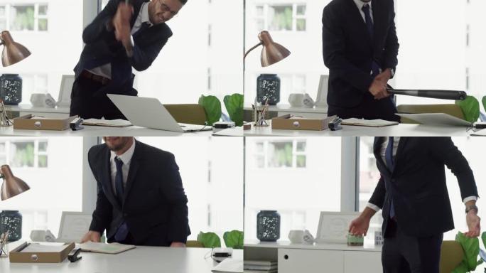 4k视频片段，一名商人用棒球棍砸碎笔记本电脑，然后翻转桌子