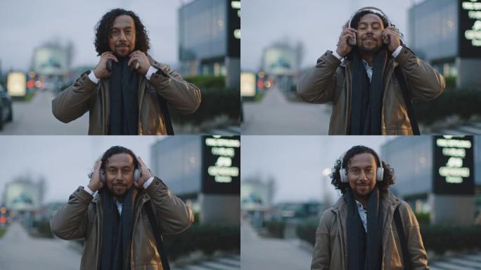 SLO MO西班牙裔男子将无线耳机放在耳朵上，而je在人行道上摆姿势