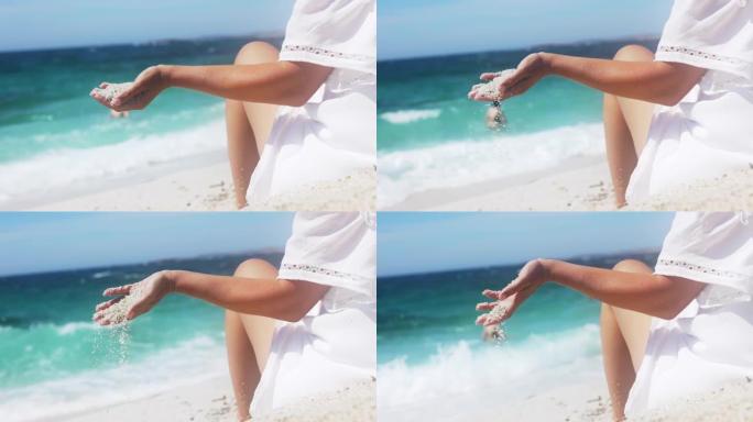 意大利玩沙子的女人的手的慢动作视图。