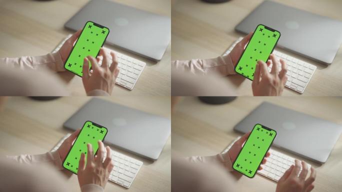 女人使用绿屏智能手机