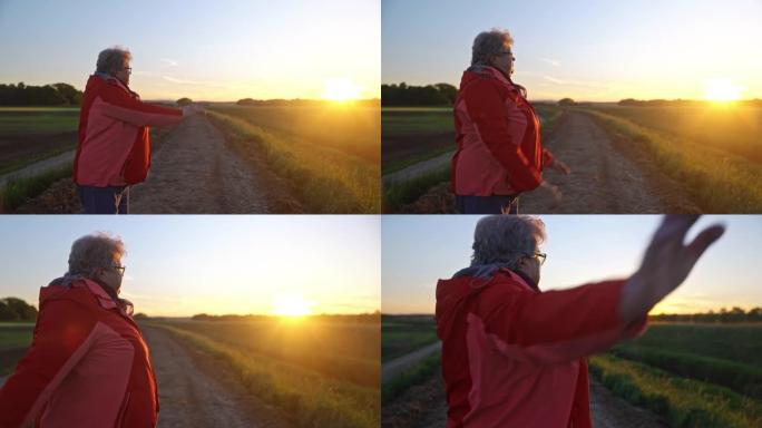 WS一名老年妇女在日落时做伸展运动