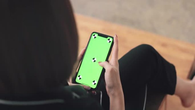 商业女性在工作中使用带有绿屏的智能手机