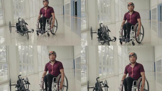 亚洲男子残疾运动员穿着制服，坐在健身房走廊的轮椅上。