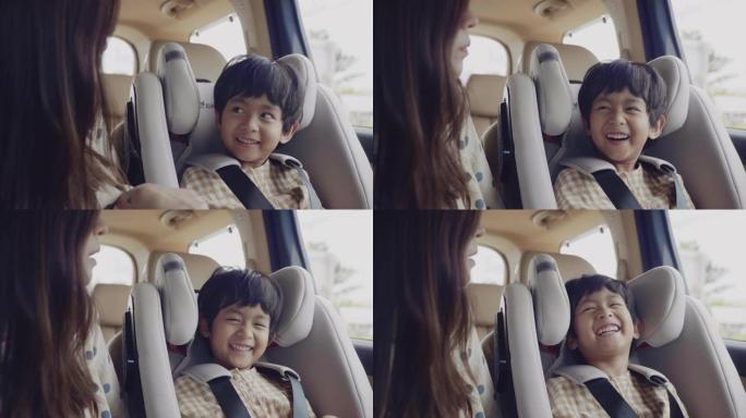 儿童安全汽车座椅中的亚洲男孩。