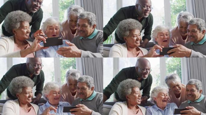 一群不同的老年人在家里一起使用智能手机