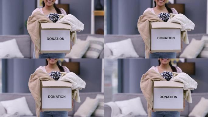 一名年轻女子在家中拿着一盒衣服捐赠的4k视频片段