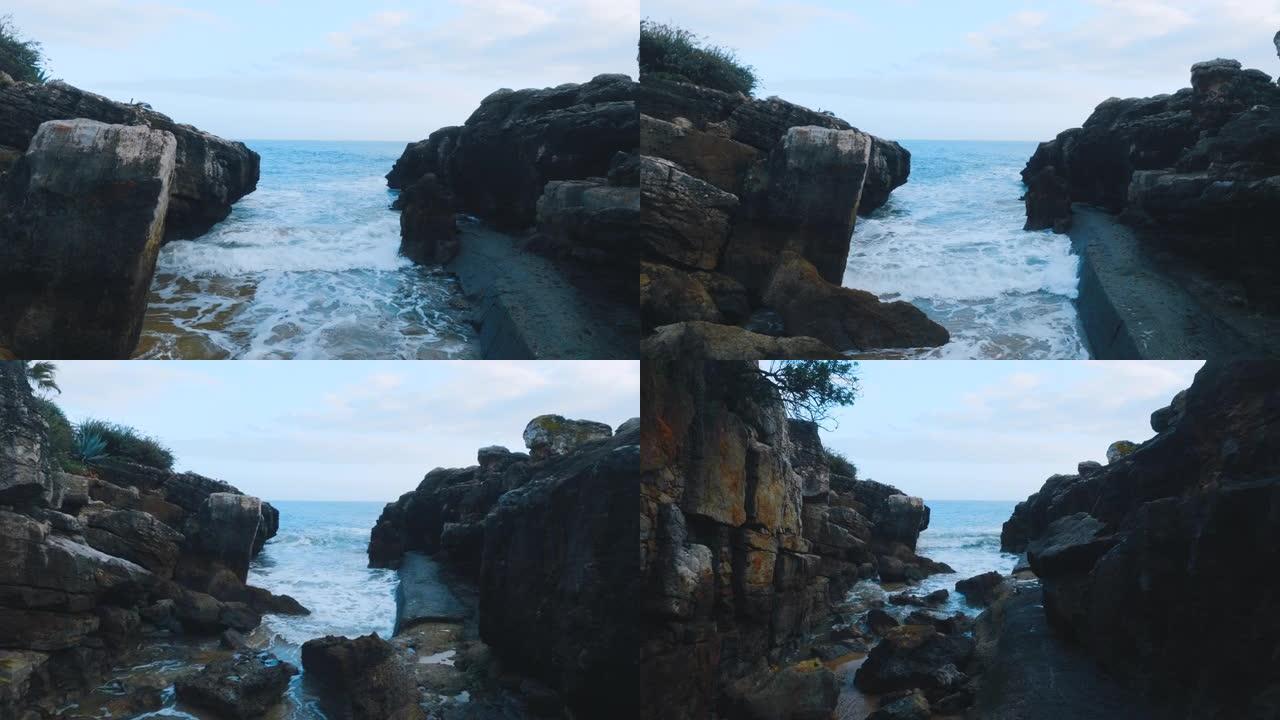 海浪冲击了卡斯卡伊斯的海岸线。多云的天气，岩石站在海里的景色