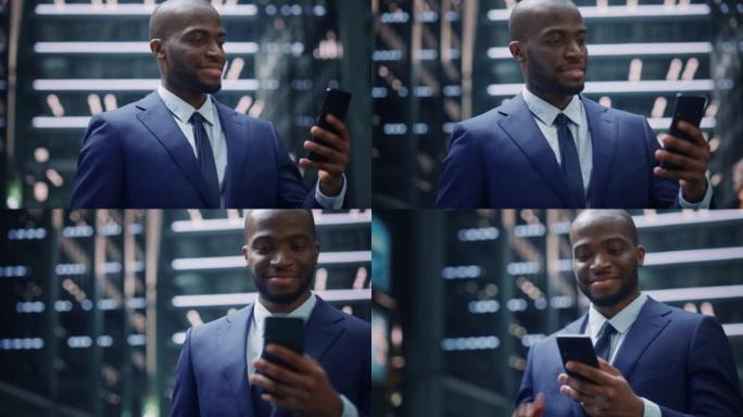 成功的非裔美国商人在城市商业区的街道上使用智能手机的肖像。黑数字创业者用手机电商App做股市投资