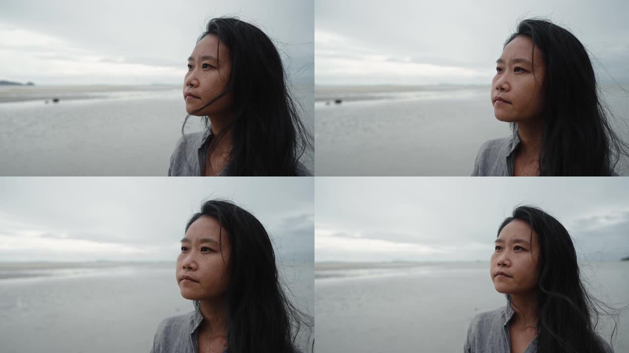 海滩上沉思的女人的肖像
