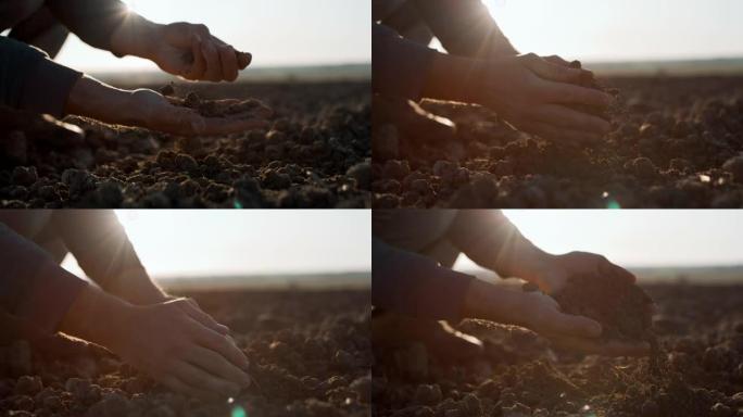 SLO MO Farmer的手在日落时在田野上挖土