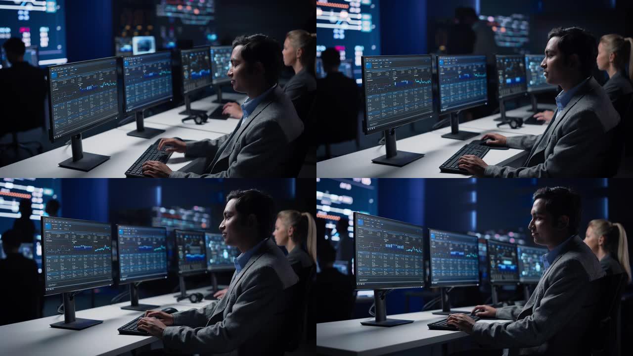自信的男性数据科学家在大型基础设施控制室的个人计算机上工作。股市女性专家使用计算机显示图表，图表，信