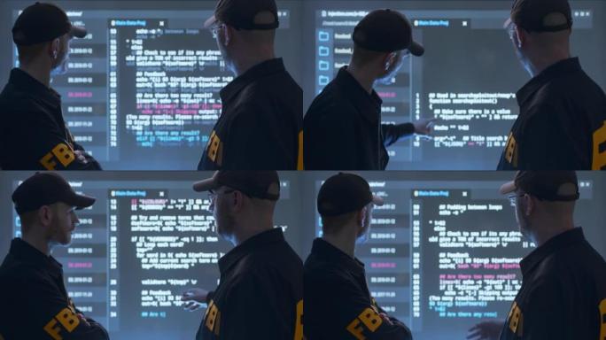 FBI探员在带有代码的巨大未来感HUD屏幕前工作