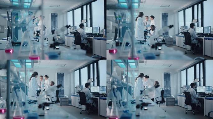 医学实验室与不同的多种族微生物科学家团队就开发药物，医学，进行生物技术研究开会。在计算机上工作，分析
