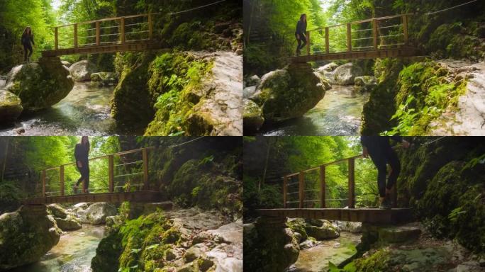 年轻女子在绿色景观的山间小溪上的木桥上行走
