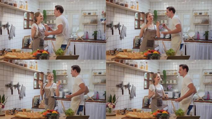 幸福的夫妻在厨房里一起跳舞