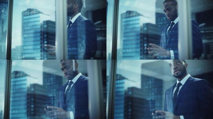 成功的黑人商人的肖像穿着西装站着，用智能手机看着窗外。成功的非洲首席执行官计划电子商务投资策略，谈判