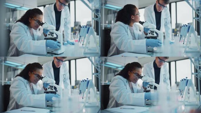现代医学研究实验室: 黑人和高加索人的年轻科学家使用显微镜，数字平板电脑，进行样本分析，交谈。在高级