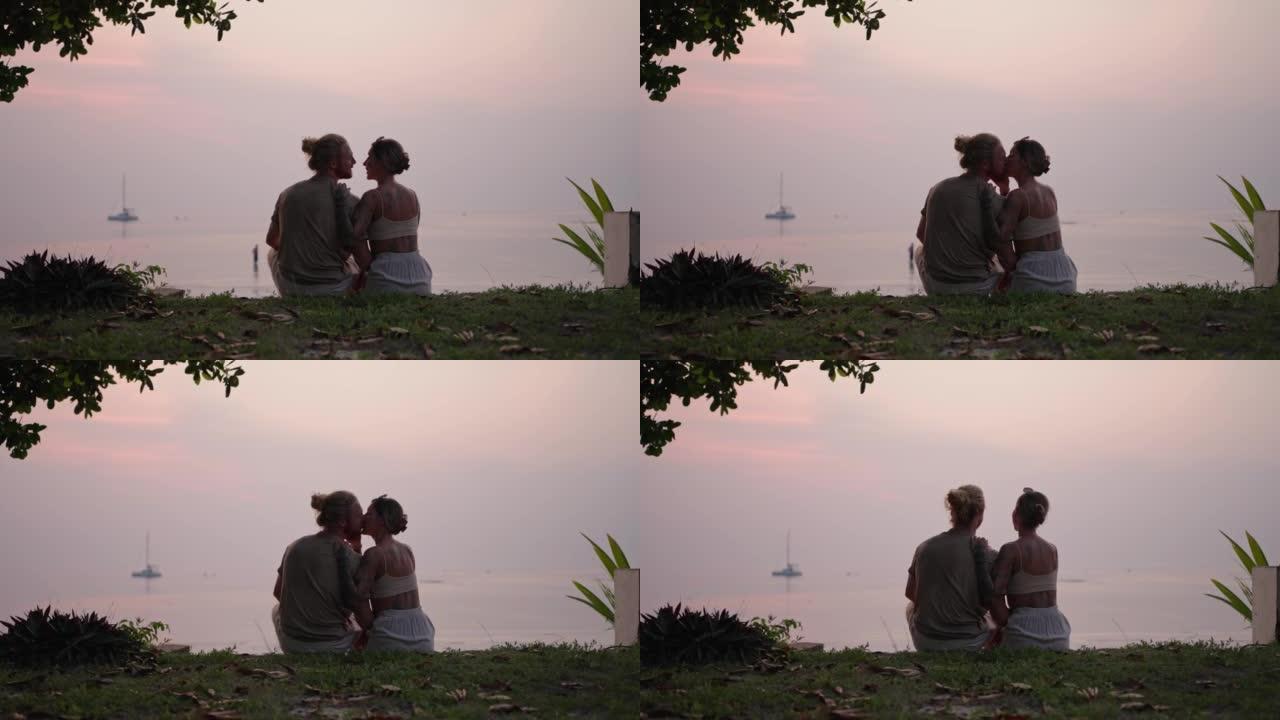 日落时的浪漫之吻情侣约会接吻浪漫海滩边