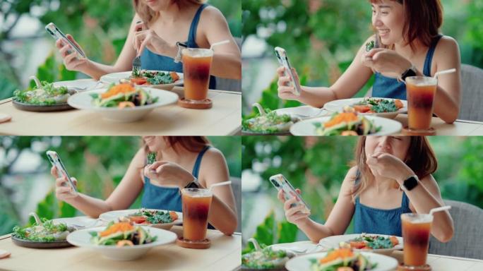快乐的女人分享健康的食物照片为社交网络。