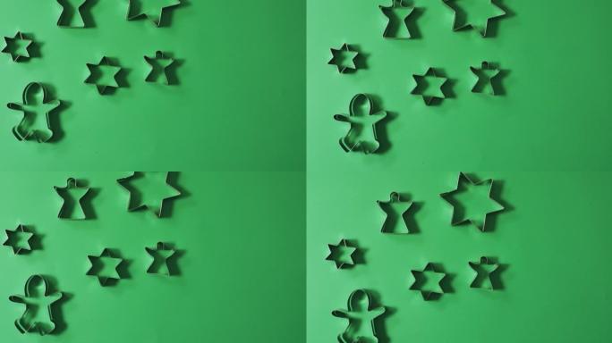 天使，姜饼人和星形饼干切割机和绿色背景上的复制空间
