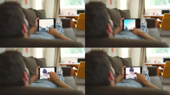 一名男子使用数字平板电脑浏览照片的4k视频片段