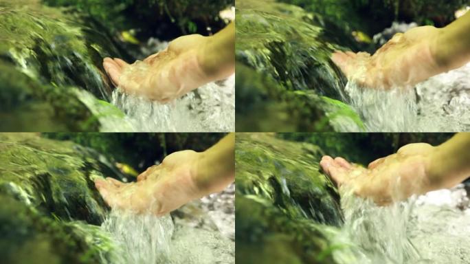 女人的手从溪流中拔罐淡水