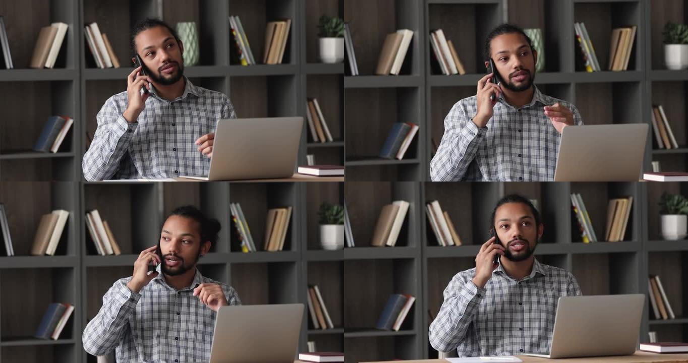 严肃的非洲男性企业家通过电话与客户交谈