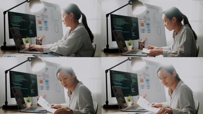 年轻的亚洲开发者在现代办公室的电脑桌面上编码移动应用程序