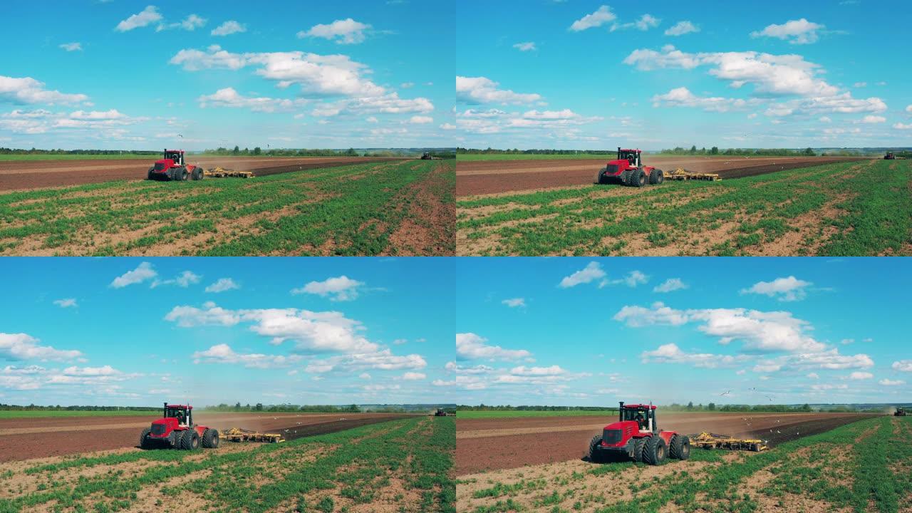 红色拖拉机为播种准备土壤。